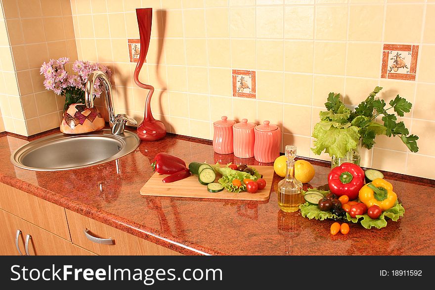 Fresh vegetables and olive oil on a kitchen table. Fresh vegetables and olive oil on a kitchen table