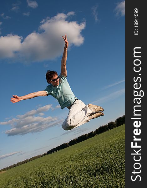 Young happy man jumping outside. Young happy man jumping outside