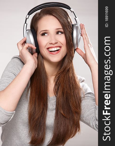 Portrait of beautiful brunette woman on natural background, with headphones. Portrait of beautiful brunette woman on natural background, with headphones