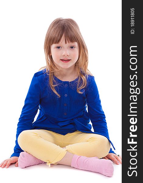 Blonde smiling little girl sitting in front of camera