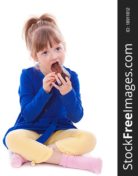 Hungry little girl eating cake