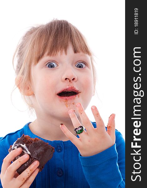 Surprised hungry girl dirty with chocolate cake looking at camera