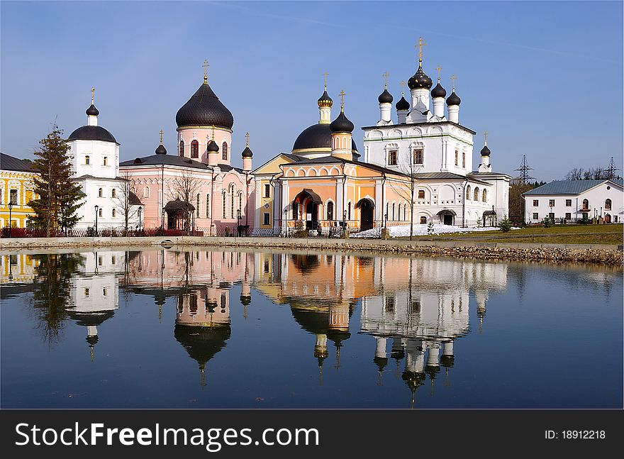 Reflection of the Monastery in the monastery pond in spring