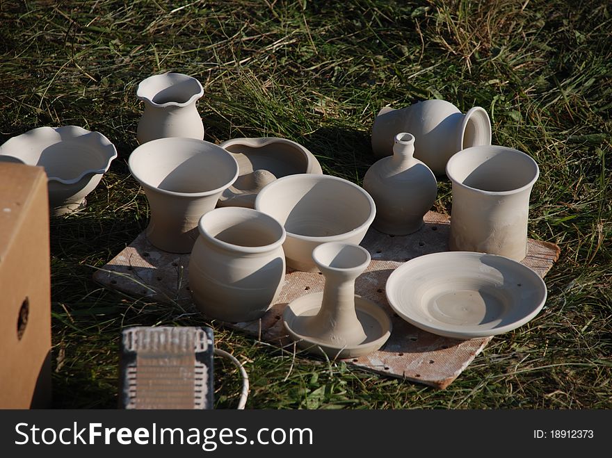 Handmade ceramics on grass background