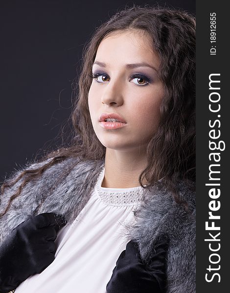 Young sensual girl close-up portrait in fur coat