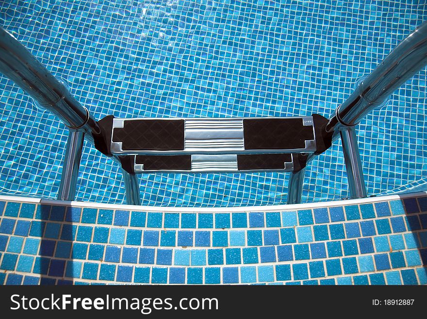 Pool ladder down, blue tiles