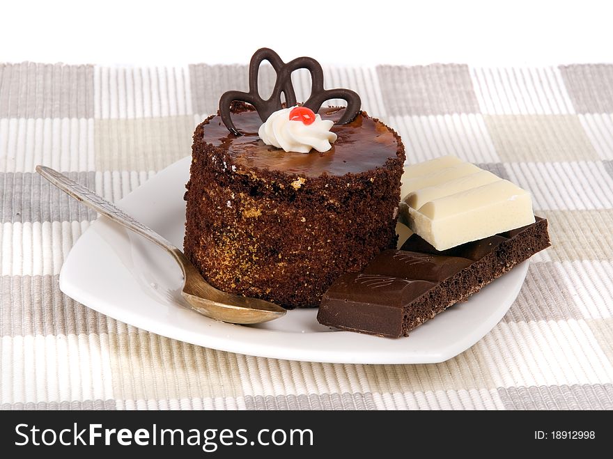 Cake with chocolate on textile mat