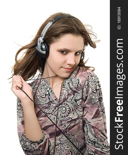 Teenage girl listening music on a white background