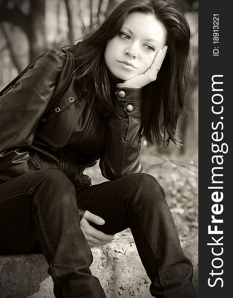 Portrait of a pensive girl sitting on the ground. Portrait of a pensive girl sitting on the ground