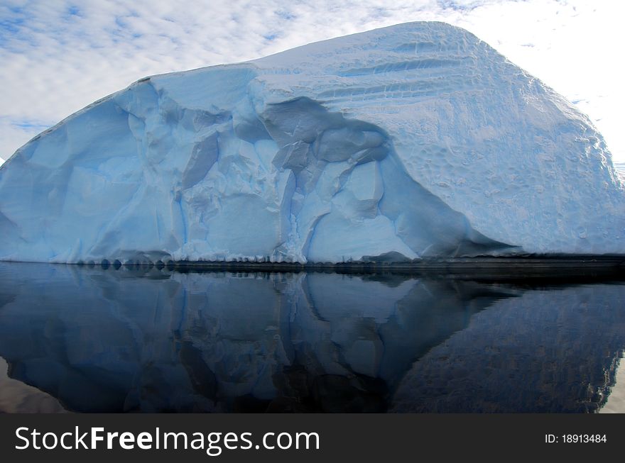 Iceberg reflected in dark ocean. Iceberg reflected in dark ocean