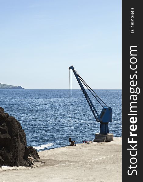 Port crane in a small harbor, Pico, Azores