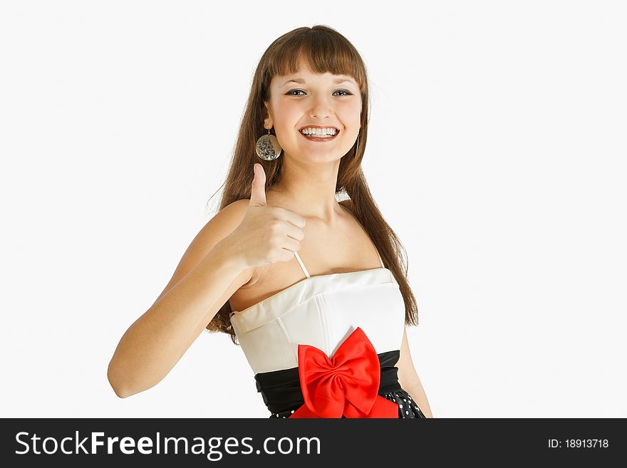 Beautiful Fashion Girl Smiling and showing thumb up. Landscape. Close-up. A look at the camera. Black skirt with white polka dots. Topic white with a red bow at the waist. On a white background. Beautiful Fashion Girl Smiling and showing thumb up. Landscape. Close-up. A look at the camera. Black skirt with white polka dots. Topic white with a red bow at the waist. On a white background.