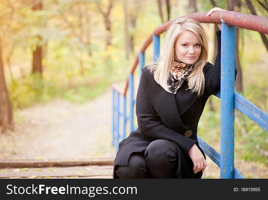 Autumn portrait of blonde girl on the Bridge. Autumn portrait of blonde girl on the Bridge