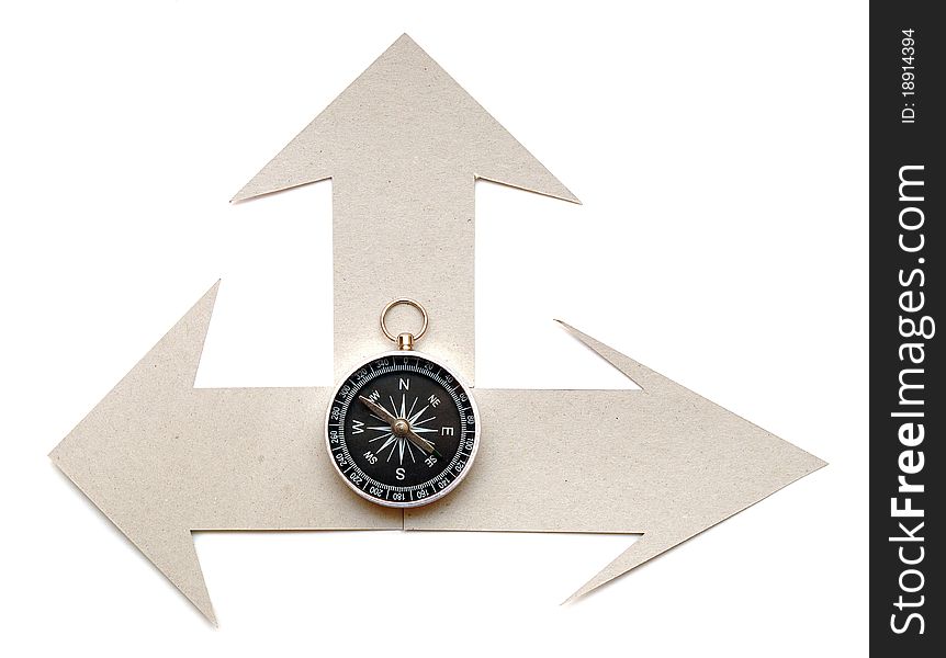 Cardboard navigation arrows with compass on a white background