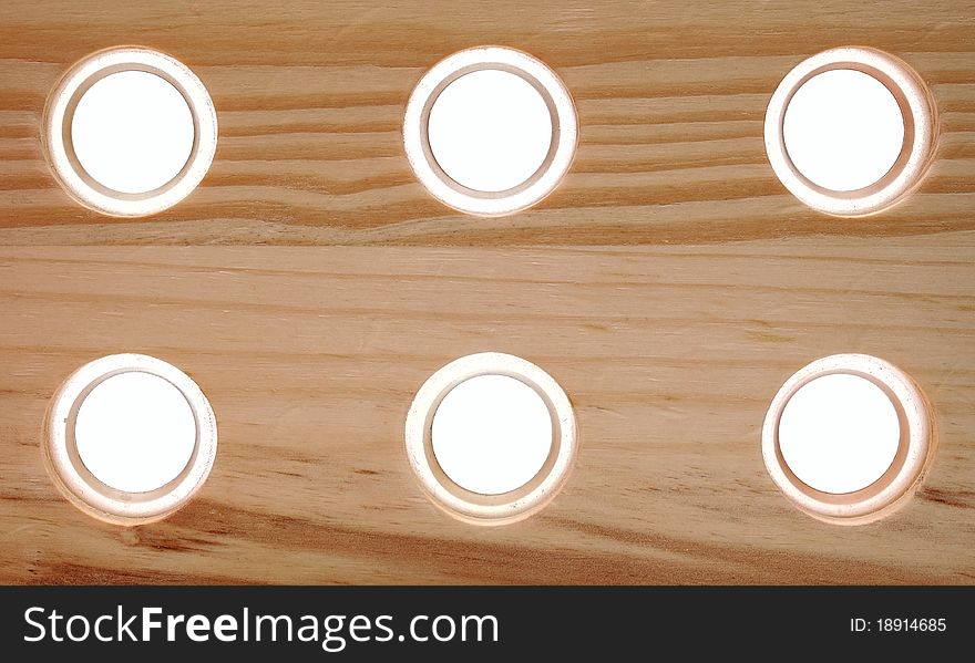 Wooden board with holes on white background