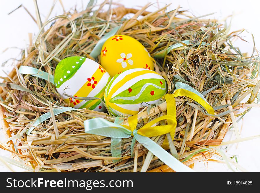 Closeup basket with colorful Easter Eggs isolated in studio