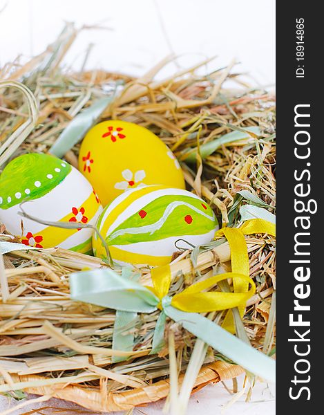 Closeup basket with colorful Easter Eggs isolated in studio