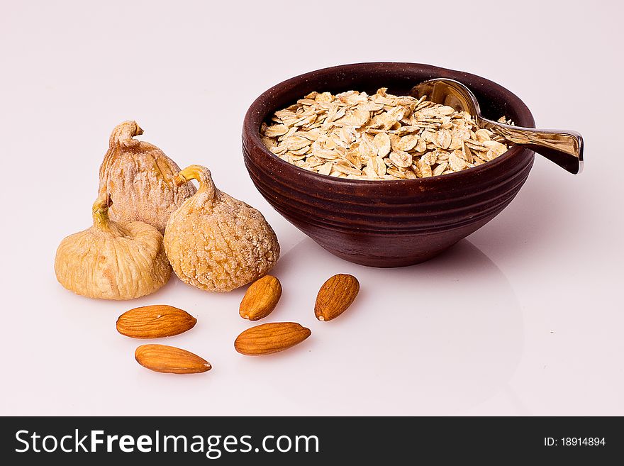 Oatmeal,figs and nut on the white background. Oatmeal,figs and nut on the white background