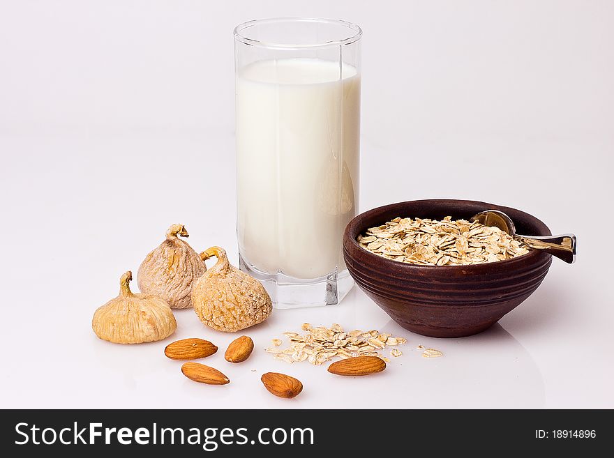 Oatmeal,milk,figs and nut on the white background. Oatmeal,milk,figs and nut on the white background