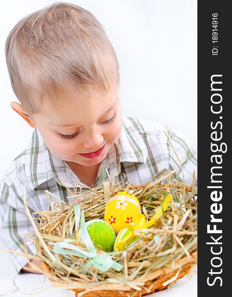 Little boy with easter eggs in basket