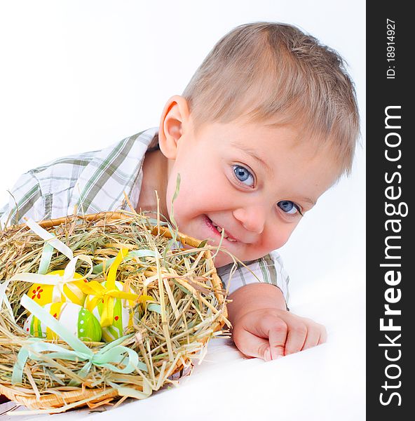 Little boy playing with easter eggs in basket. Little boy playing with easter eggs in basket