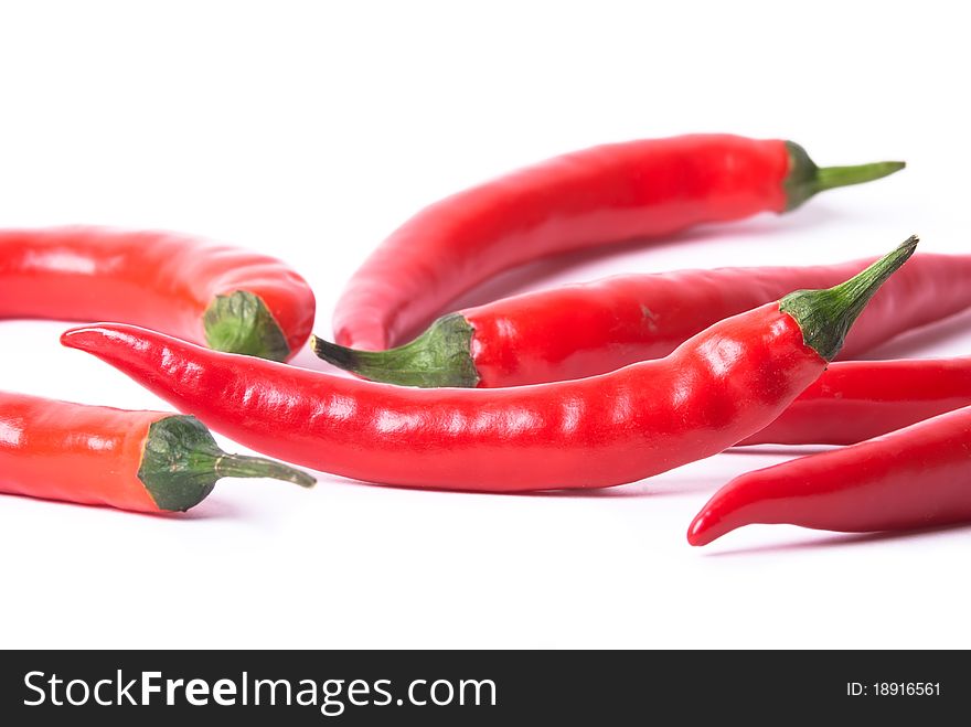 Many red peppers on a white background optional