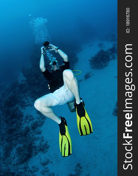 Scuba diver with underwater camera. Scuba diver with underwater camera