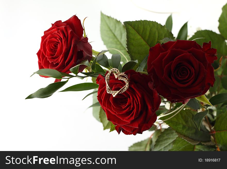 Bouquet of three red roses and gold heart on white background. Bouquet of three red roses and gold heart on white background.