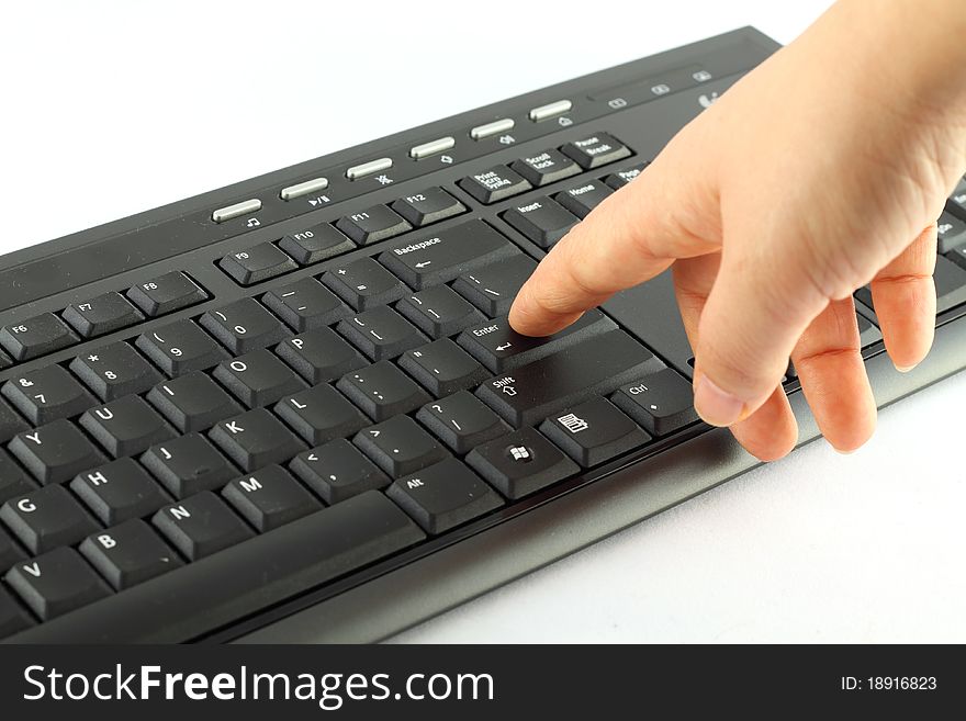 Hand on the black keyboard isolated on white. Hand on the black keyboard isolated on white.