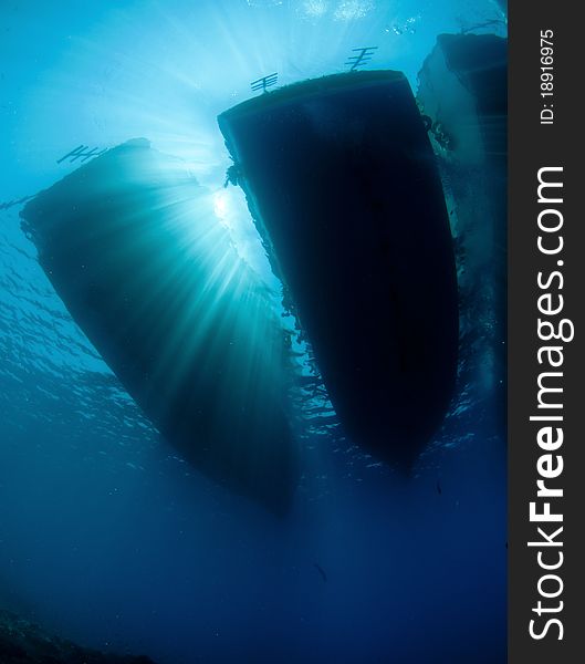 Scuba diving boats with ray of sunlight from under the water. Scuba diving boats with ray of sunlight from under the water