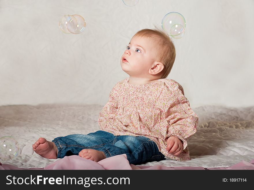 Closeup portrait of little cute baby girl with bubbles. Closeup portrait of little cute baby girl with bubbles