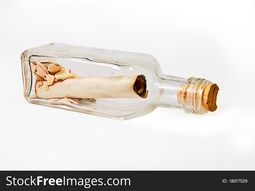 A message written in a scroll inside a bottle with some rocks. A message written in a scroll inside a bottle with some rocks