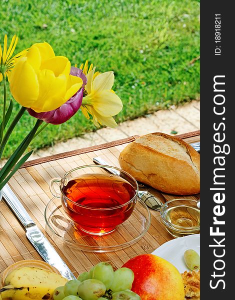 Tea and simple food on a wooden table in the garden. Tea and simple food on a wooden table in the garden.