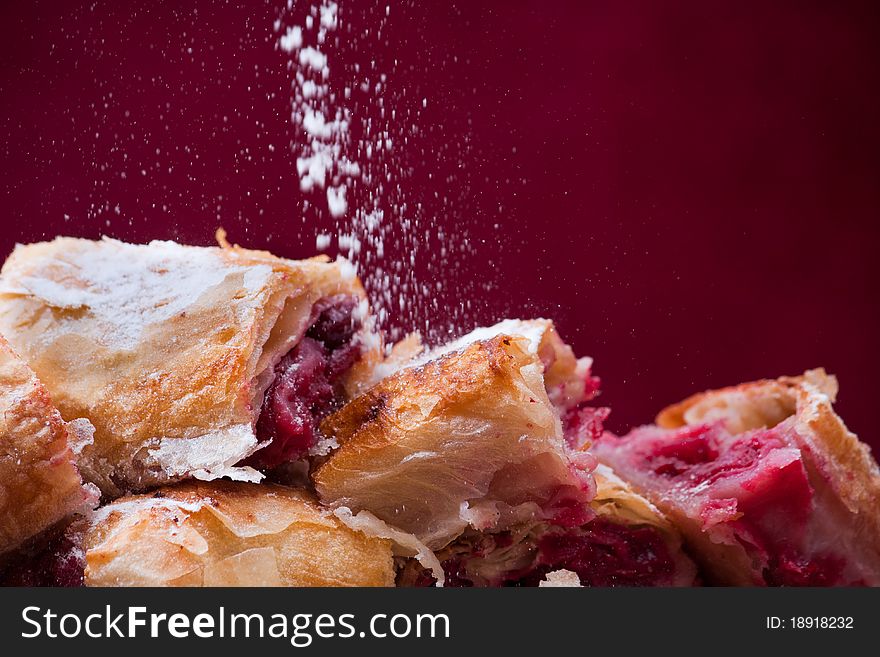 Cherry pie slices with fine sugar on top. This is traditional Balkan pie with cherry fruit. It is made differently from American pie.