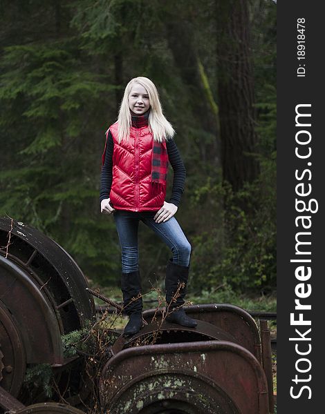 Beautiful young teenage girl sitting on her suitcase in the middle of railroad tracks. Beautiful young teenage girl sitting on her suitcase in the middle of railroad tracks.