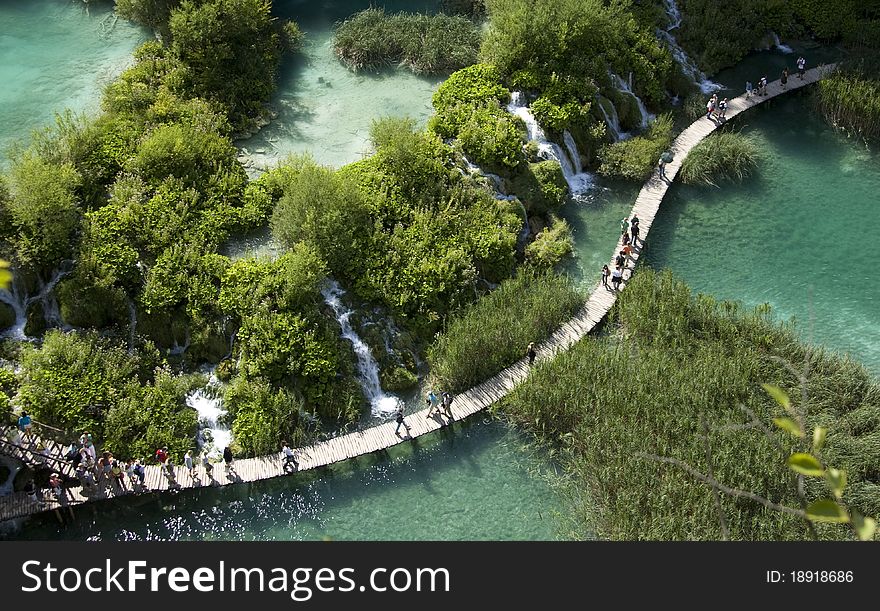 Wooden pathway in the forest next to a stream in Plitvice Lakes of Croatia