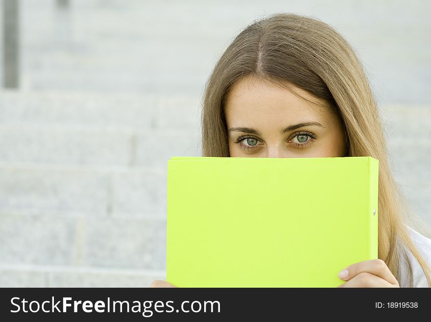 Attractive young businesswoman smiling with a green folder. Attractive young businesswoman smiling with a green folder.