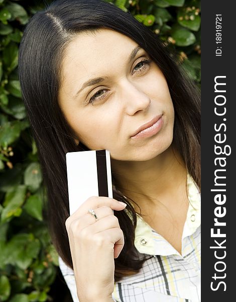 Young beautiful woman outdoors with a plastic credit card. Young beautiful woman outdoors with a plastic credit card