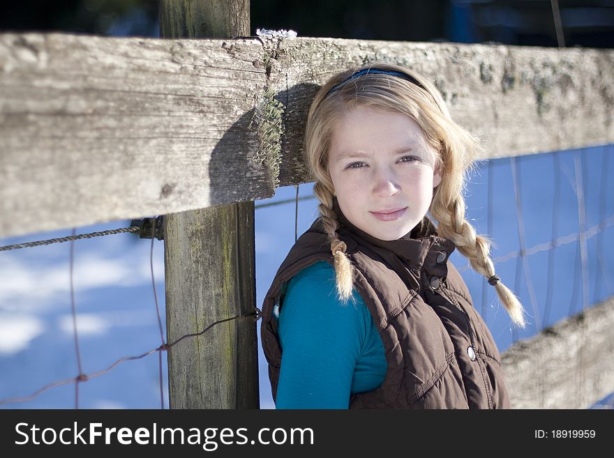 Young girl posing for the camera in a field of snow. Young girl posing for the camera in a field of snow