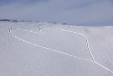 Heart Shaped Trails In A Snow Slope Royalty Free Stock Image