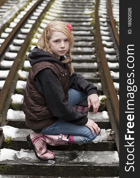 Young girl posing for the camera in a field of snow. Young girl posing for the camera in a field of snow