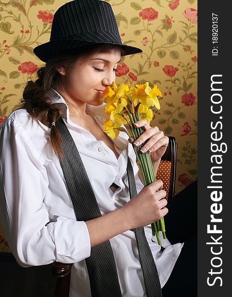 Portrait of the beautiful stylish brunette woman with narcissuses