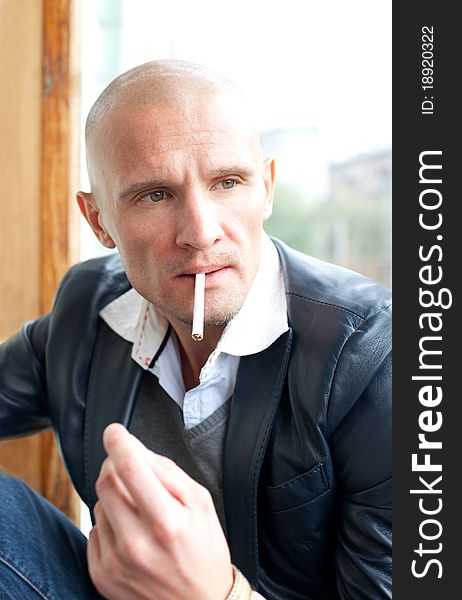 Young man with cigarette thinking