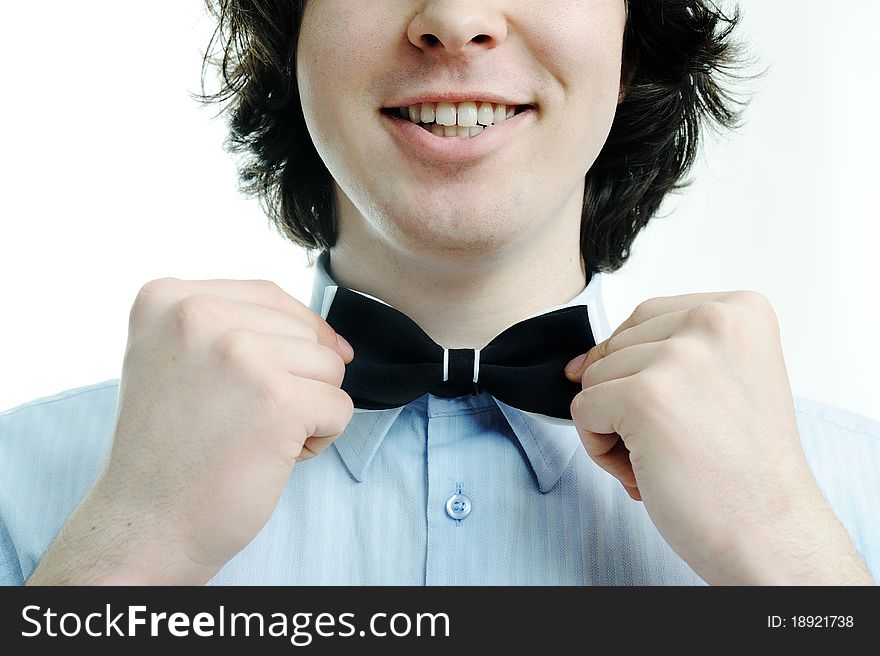 An image of a young waiter touching his tie