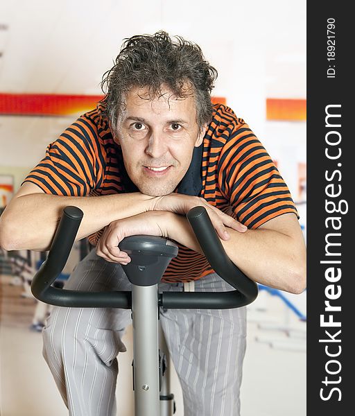 Man with sport clothes riding a static bike. Man with sport clothes riding a static bike