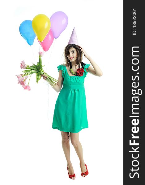 A young beautiful woman with flowers and balloons. A young beautiful woman with flowers and balloons