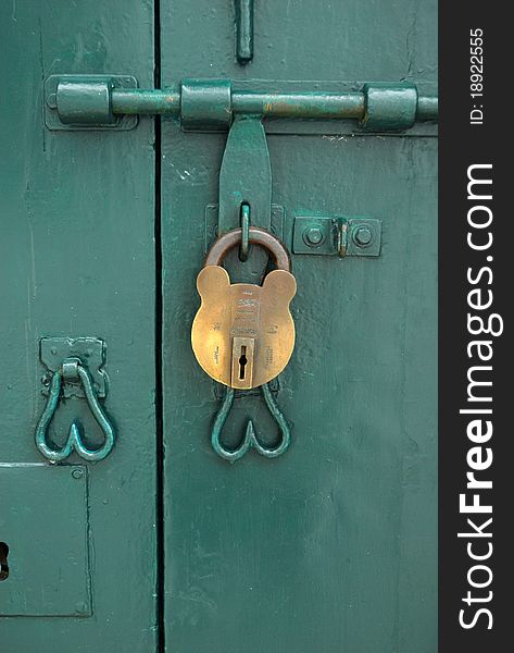 A mickey mouse shape lock on the green doors. A mickey mouse shape lock on the green doors