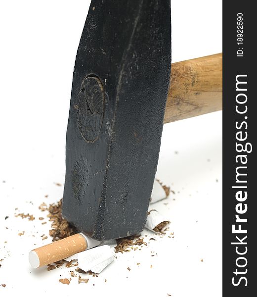 Cigarette smashed with hammer on white
