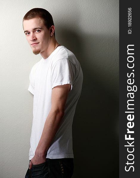 Young man poses wearing t-shirt and jeans. Young man poses wearing t-shirt and jeans.