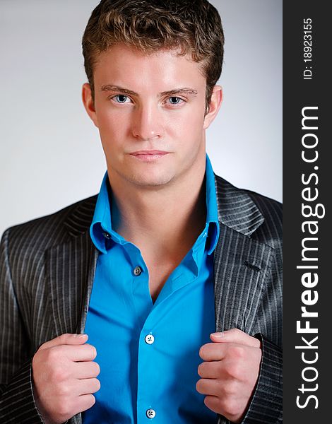 Young man poses wearing jacket and button shirt. Young man poses wearing jacket and button shirt.